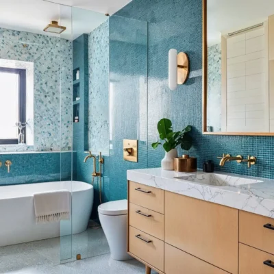 Bright and airy bathroom with a white floating vanity, freestanding bathtub, and glass shower enclosure. The room is decorated with plants and minimalistic elements.